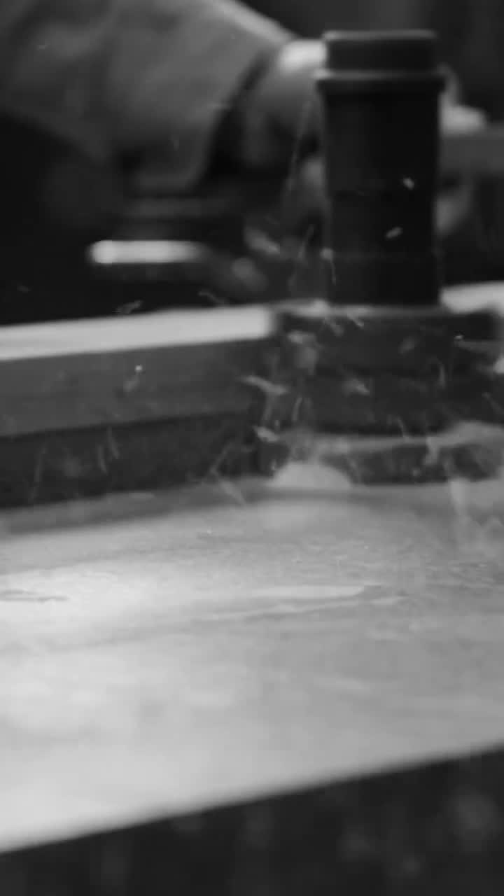 Hands shaping a ceramic vessel in a workshop
